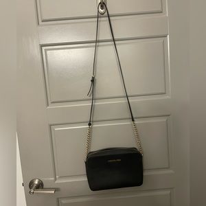 Michael Kors Jet Set East West Crossbody in black and gold.